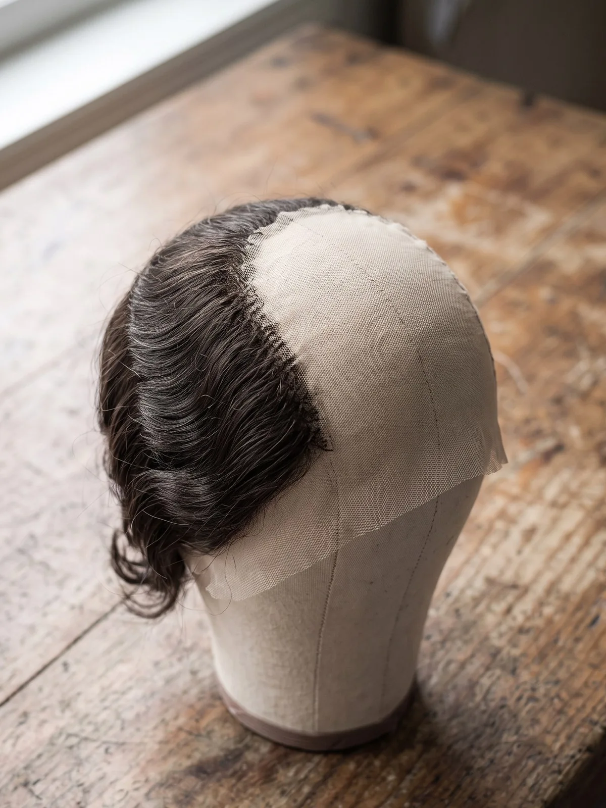 Artisans hand-tying wigs at workstations in Khanh Hoa Vietnam